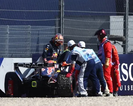 Marshals assist Max Verstappen after he crashed his Red Bull