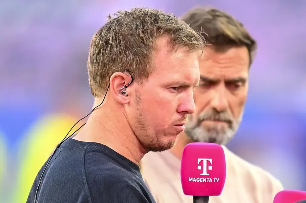 Julian Nagelsmann holding a microphone and standing next to Jurgen Klopp