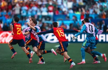 Spain’s substitutes run onto the pitch in celebration as the final whistle blows in Sunday’s World Cup final
